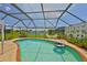 Enclosed pool featuring a brick border, seating area, and view of the serene waterfront at 1811 Milford Cir, Sun City Center, FL 33573