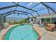 Relaxing screened-in pool area with comfortable seating, perfect for outdoor enjoyment at 1811 Milford Cir, Sun City Center, FL 33573