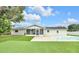Beautiful backyard showcasing the pool, turf, patio, and exterior of the home at 2106 Sherbrook Dr, Valrico, FL 33594