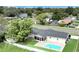 Aerial view of backyard with a pool, patio, green grass and a screened in porch at 2106 Sherbrook Dr, Valrico, FL 33594