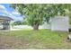 Backyard featuring a storage shed, inground pool and an enclosed patio with a large shade tree at 2106 Sherbrook Dr, Valrico, FL 33594