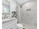 Elegant bathroom featuring a marble-style shower, modern fixtures, and a vanity with countertop space at 2106 Sherbrook Dr, Valrico, FL 33594