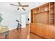 Versatile bedroom space with hardwood floors, ceiling fan, built-in storage, and access to the living room area at 2106 Sherbrook Dr, Valrico, FL 33594