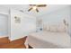 Bright bedroom featuring hardwood floors, a ceiling fan, and ample closet space at 2106 Sherbrook Dr, Valrico, FL 33594
