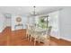 Elegant dining room featuring a chandelier, large window, and hardwood floors, perfect for gatherings at 2106 Sherbrook Dr, Valrico, FL 33594