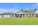 Charming brick home featuring a well-manicured lawn, attached garage, and a cozy front porch at 2106 Sherbrook Dr, Valrico, FL 33594