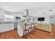 Modern kitchen with stainless steel appliances, a spacious island, and hardwood floors, perfect for cooking at 2106 Sherbrook Dr, Valrico, FL 33594