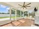 Inviting screened sunroom with wood-look tile floors and comfortable seating at 2106 Sherbrook Dr, Valrico, FL 33594