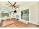 Covered lanai with wood-look floors, ceiling fan, and a sliding glass door for easy access to backyard at 2106 Sherbrook Dr, Valrico, FL 33594