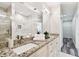 Modern bathroom featuring marble shower, granite countertop, double sink, and ample space at 2405 W North B St # 1, Tampa, FL 33609