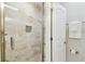 Bathroom features a glass door shower and easy access to the toilet with towel rack and open door at 2405 W North B St # 1, Tampa, FL 33609