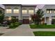 Well-manicured front yard and driveway leading to a two-story home with a two-car garage at 2405 W North B St # 1, Tampa, FL 33609