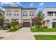 Charming townhome with a well-manicured lawn, complemented by a crape myrtle and a stone-accented garage at 2405 W North B St # 1, Tampa, FL 33609