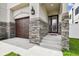 Inviting front porch featuring stone accents, stylish lighting and a modern front door at 2405 W North B St # 1, Tampa, FL 33609