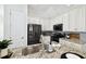 Modern kitchen with black stainless appliances, granite counters and white cabinets at 2405 W North B St # 1, Tampa, FL 33609