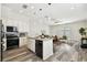 Bright, open kitchen with white cabinets, island, granite counters, and stainless steel appliances at 2405 W North B St # 1, Tampa, FL 33609