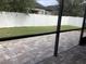 Backyard featuring a well-maintained lawn, a white vinyl fence, and a brick patio at 2588 Bartolo Dr, Land O Lakes, FL 34639