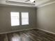 Bedroom showcasing neutral-colored walls and wood-look flooring at 2588 Bartolo Dr, Land O Lakes, FL 34639
