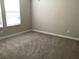 Bedroom view showing neutral carpet, two windows with blinds, and light-colored walls at 2588 Bartolo Dr, Land O Lakes, FL 34639