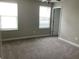 Bright bedroom featuring neutral walls, carpet, and two windows allowing natural light at 2588 Bartolo Dr, Land O Lakes, FL 34639