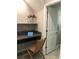 Cozy nook featuring a granite desk, woven chair, and shelf with pink flowers at 2588 Bartolo Dr, Land O Lakes, FL 34639