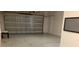 Spacious two car garage with a white epoxy floor and insulated garage doors at 2588 Bartolo Dr, Land O Lakes, FL 34639