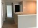 Hallway showcasing white walls, neutral carpet, and multiple doorways at 2588 Bartolo Dr, Land O Lakes, FL 34639