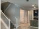 Interior shot of staircase leading to hallway with white walls and tiled floors at 2588 Bartolo Dr, Land O Lakes, FL 34639