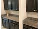 Kitchen area with black cabinets and granite countertops at 2588 Bartolo Dr, Land O Lakes, FL 34639
