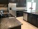 Bright kitchen featuring granite countertops, stainless steel appliances and dark wood cabinetry at 2588 Bartolo Dr, Land O Lakes, FL 34639