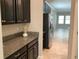Kitchen area with black cabinets, granite countertop, and stainless steel appliances at 2588 Bartolo Dr, Land O Lakes, FL 34639