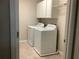Laundry room showcasing a washer, dryer, white cabinets, and tiled floor at 2588 Bartolo Dr, Land O Lakes, FL 34639