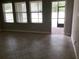 An empty living room with tile floors and a view to the exterior of the home at 2588 Bartolo Dr, Land O Lakes, FL 34639