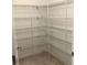 A large walk-in pantry features wire shelving and neutral tile floors at 2588 Bartolo Dr, Land O Lakes, FL 34639