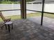 A screened patio featuring paver floors and a patio set at 2588 Bartolo Dr, Land O Lakes, FL 34639