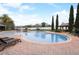 Beautiful community pool with brick decking, lounge chairs, palm trees, and clear blue water at 2588 Bartolo Dr, Land O Lakes, FL 34639