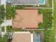 Aerial view of the home with a shingle roof and a fenced backyard with palm trees at 27810 Sky Lake Cir, Wesley Chapel, FL 33544