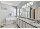 Bathroom features a double vanity, tub, and separate shower for a luxurious experience at 27810 Sky Lake Cir, Wesley Chapel, FL 33544