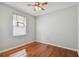 Bedroom with wood floors, gray walls, a ceiling fan, and a window with blinds at 27810 Sky Lake Cir, Wesley Chapel, FL 33544