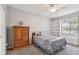 Comfortable bedroom with a window seat, a ceiling fan and a large dresser offers a relaxing space at 27810 Sky Lake Cir, Wesley Chapel, FL 33544