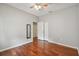 The bedroom has wood floors, a ceiling fan, closet, and a mirror on the wall at 27810 Sky Lake Cir, Wesley Chapel, FL 33544