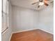 Bright bedroom with hardwood floors, a ceiling fan, and a window with blinds offers a cozy retreat at 27810 Sky Lake Cir, Wesley Chapel, FL 33544