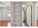 View of the bedroom with a built-in bookshelf and a bathroom in the background at 27810 Sky Lake Cir, Wesley Chapel, FL 33544