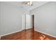 Bedroom with wood flooring, a ceiling fan, closet with doors, and gray walls at 27810 Sky Lake Cir, Wesley Chapel, FL 33544