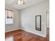 Bedroom with wood floors, a ceiling fan, window with blinds, and mirror on the wall at 27810 Sky Lake Cir, Wesley Chapel, FL 33544