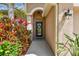 View of front door and entrance with manicured landscaping at 27810 Sky Lake Cir, Wesley Chapel, FL 33544