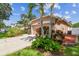 Front exterior of the home shows the driveway, garage, and attractive landscaping at 27810 Sky Lake Cir, Wesley Chapel, FL 33544