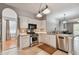 Bright kitchen featuring stainless steel appliances, white cabinetry, and a decorative tile backsplash at 27810 Sky Lake Cir, Wesley Chapel, FL 33544