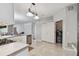 Open kitchen with stainless steel appliances, tile flooring, and convenient access to laundry area at 27810 Sky Lake Cir, Wesley Chapel, FL 33544