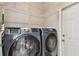 Laundry area with front-load washer and dryer, complemented by wire shelving for storage at 27810 Sky Lake Cir, Wesley Chapel, FL 33544